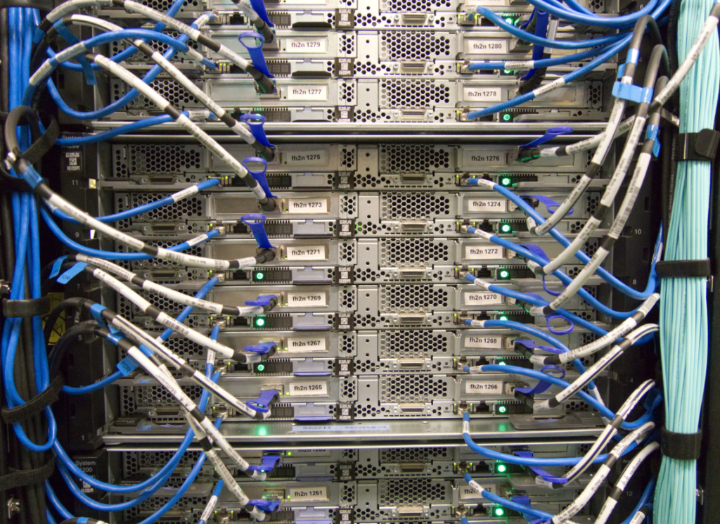 Picture of multiple servers on a server rack with network cabling